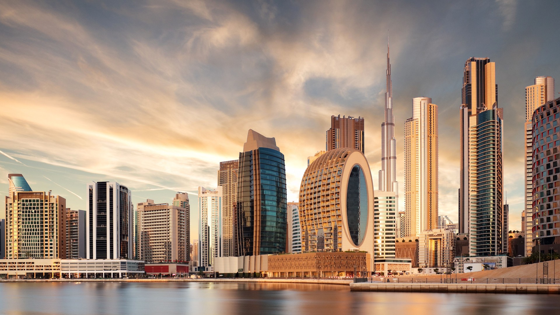 Panorama of skyline downtown Dubai at sunrise from Canal Creek, United Arab Emirates